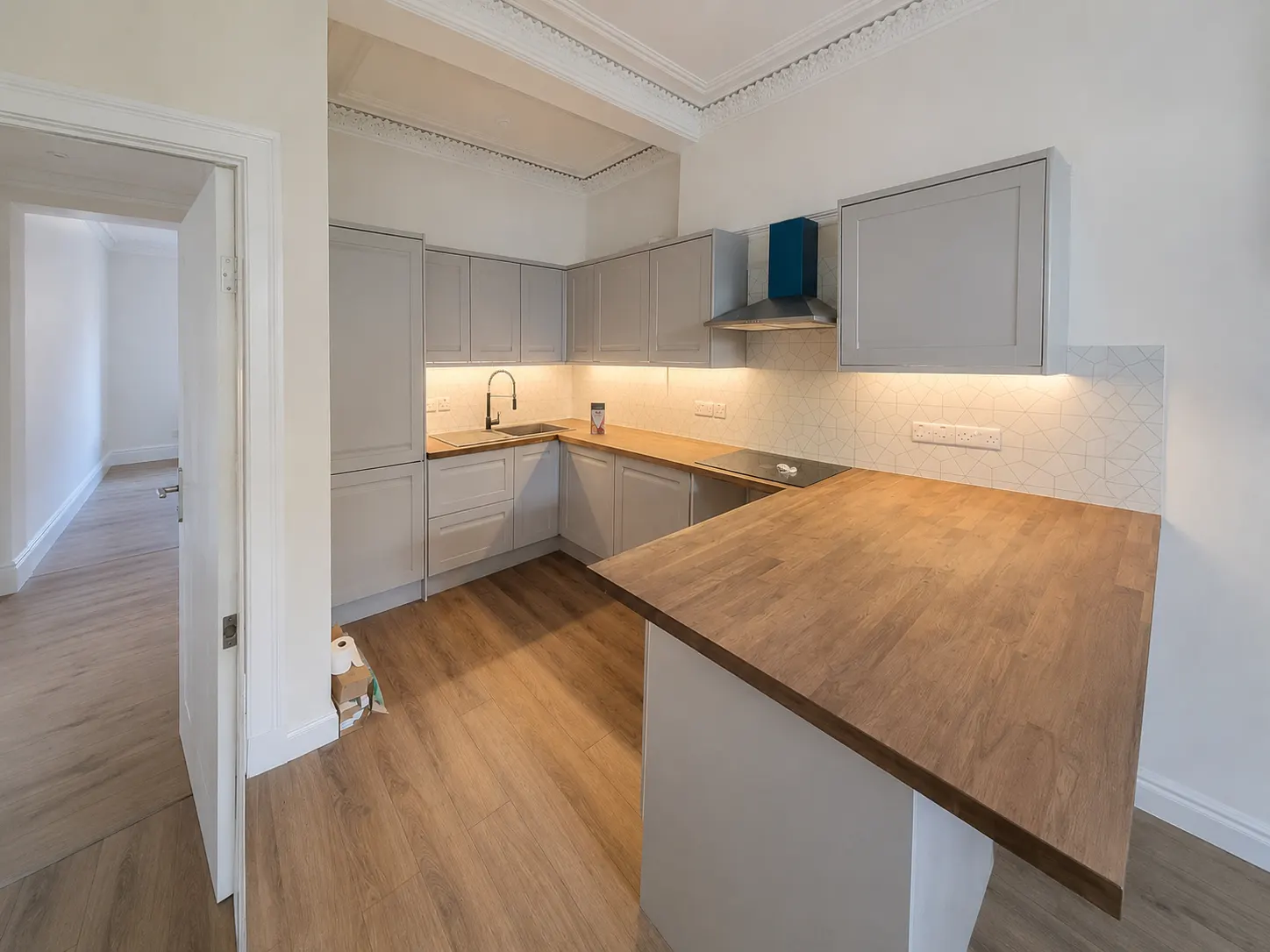 Kitchen fitting with splashback tiling in an Edinburgh home